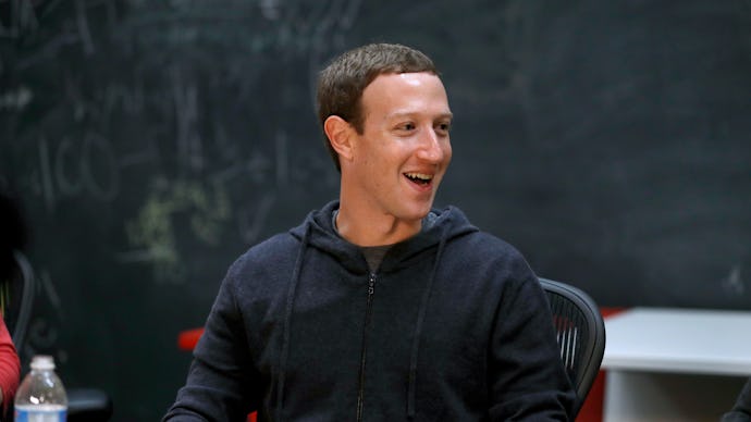 Mark Zuckerberg sitting at a desk in a black hoodie 