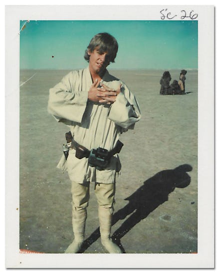 Mark Hamill behind the scenes as luke skywalker posing with his hands put together in front of him