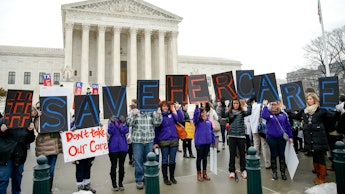 Protesters in front of the supreme court advocating for obamacare to stay