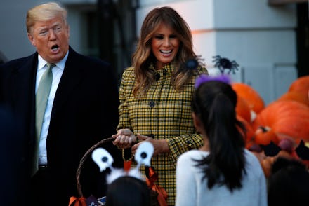 Donald Trump and Melania Trump smiling and talking to a girl from and audience