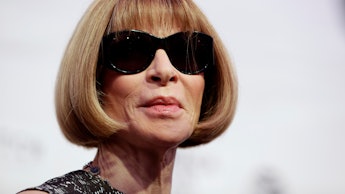 Anna Wintour posing in sunglasses at a red carpet event