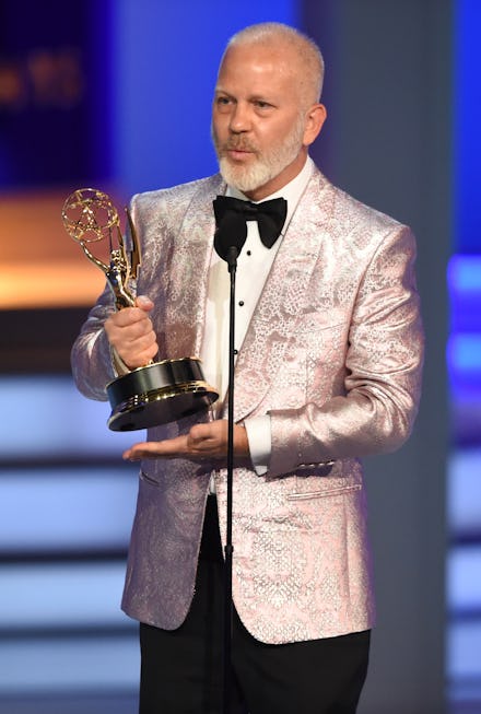 Ryan Murphy holding his Emmy award trophy