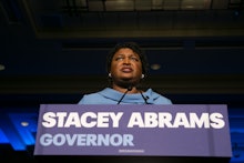 Governor Stacey Abrams in a blue dress giving a speech
