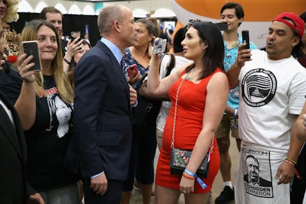 Laura Loomer taking a close photo of a politician at a rally
