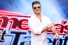 America's Got Talent Simon Cowell posing in a white shirt
