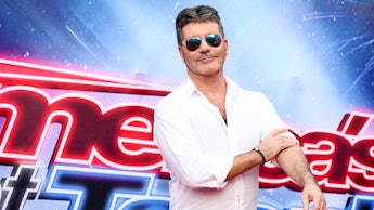 America's Got Talent Simon Cowell posing in a white shirt
