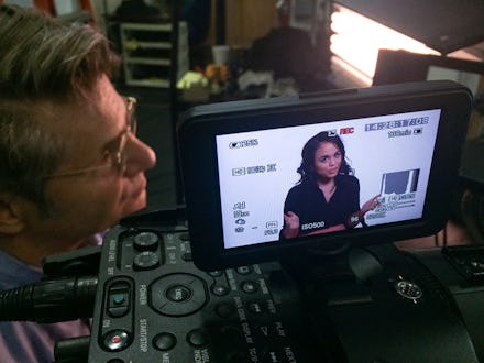 The Whiteness Project: Intersection of I team looking at the footage through the viewfinder