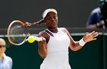 Sloane Stephens, a US Olympic tennis player, in a white dress, and a white cap during a match