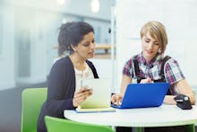 Two women sitting next to their laptops and using LinkedIn as the new Tinder