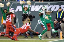 Jets vs. Bills playing in green and red jersies