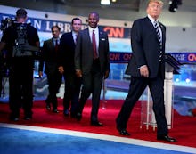 Donald Trump and a group of men walking behind him at the Third Republican Presidential Debate