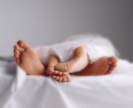 A close-up of overlapping feet of a man and a woman on Valentine's Day