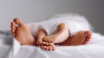 A close-up of overlapping feet of a man and a woman on Valentine's Day