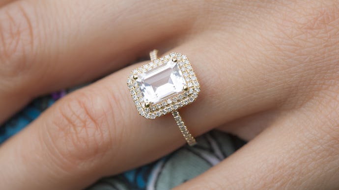 A close-up of a woman's hand and her large engagement ring