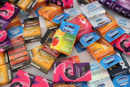 A bunch condom packages spread on a white surface