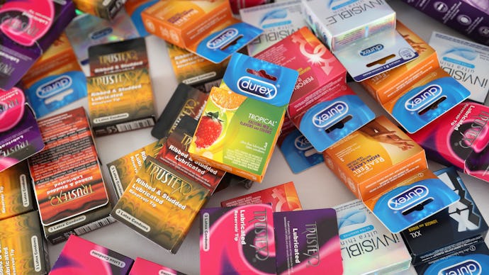A bunch condom packages spread on a white surface