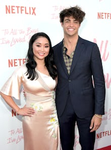 Lana Condor in a blush off-shoulder dress and Noah Centino in a black blazer