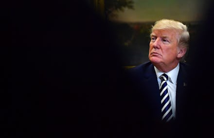 Donald Trump in a suit and tie looking to the right