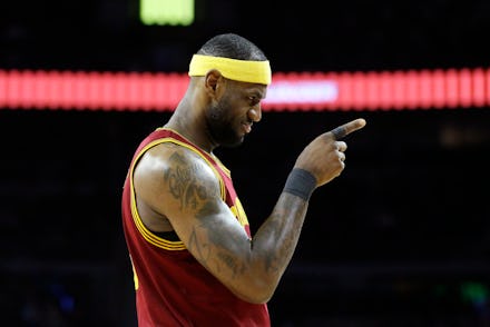 Lebron James in basketball gear pointing.