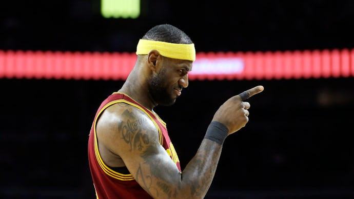Lebron James in basketball gear pointing.