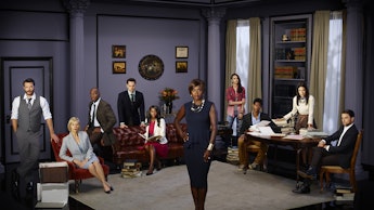 How to Get Away With Murder cast gathered around the living room set in the show 