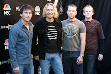 Nickelback standing next to each other during a red carpet event