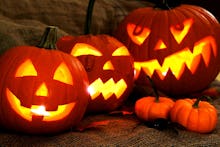 Three large carved out Pumpkin Jack O' Lanterns and two small pumpkins for Halloween 2017