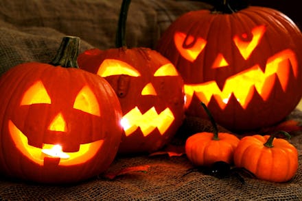 Three large carved out Pumpkin Jack O' Lanterns and two small pumpkins for Halloween 2017