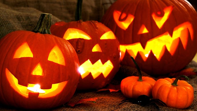 Three large carved out Pumpkin Jack O' Lanterns and two small pumpkins for Halloween 2017