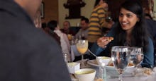 A couple having a dinner in the Karma Kitchen restaurant.