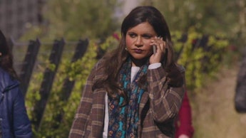 Mindy Kaling talking holding her phone and talking to someone
