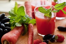 Fruits next to a juice for a cleanse diet