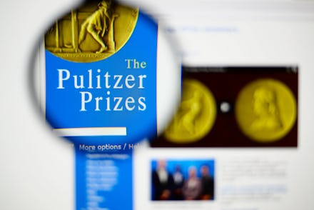 A magnifying glass of a book about the Pulitzer Prize