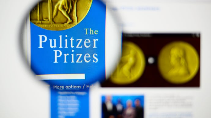 A magnifying glass of a book about the Pulitzer Prize