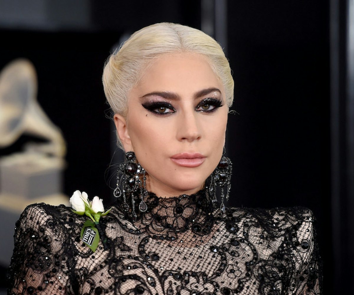 Lady gaga in a lace dress with her bleached hair and heavy black eyeshadow.