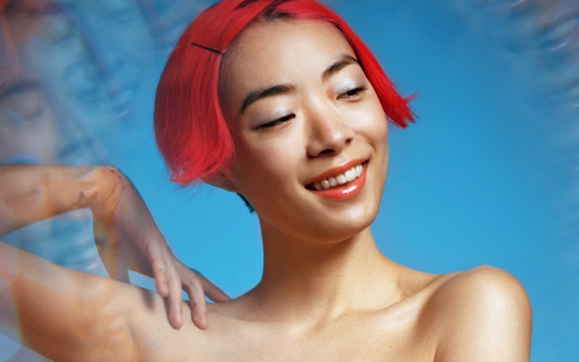 The cover of “Cherry”, song by Rina Sawayama featuring Rina Herself with short bright red hair in fr...
