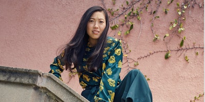 American actress and rapper Awkwafina wearing a green shirt with yellow flowers starring in ModCloth...