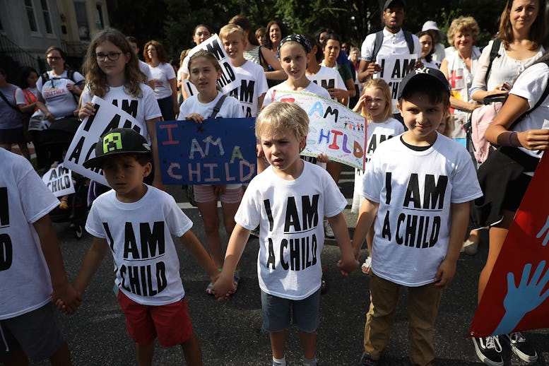 Children protesting with white shirts that have black "I am a child" text printed