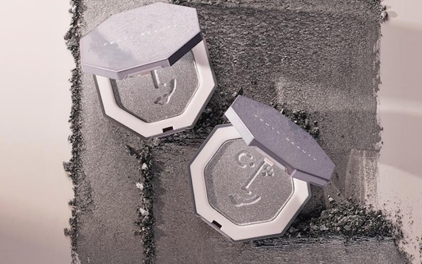 Fenty Beauty highlighters on a sandy background