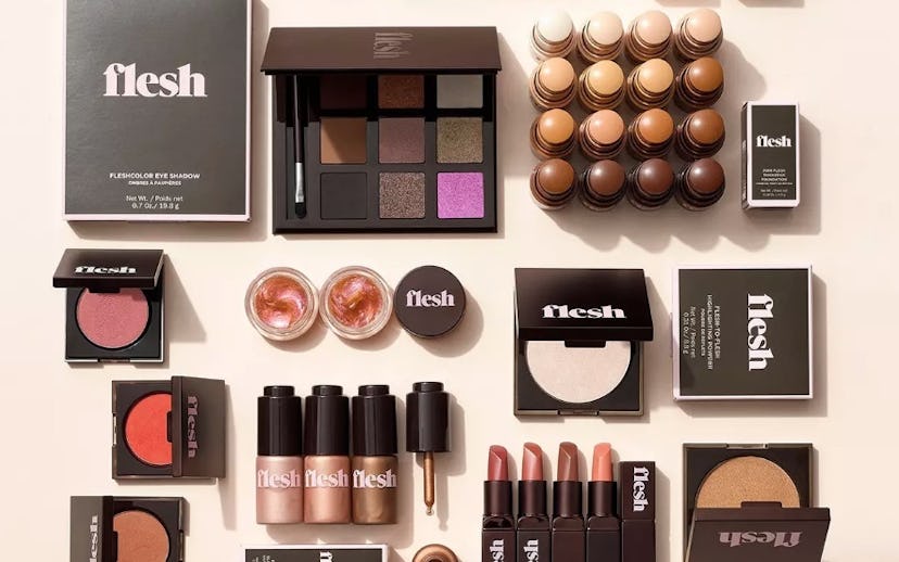 Beauty products from Flesh Beauty including eyeshadow, lipstick, foundation and glisten drops