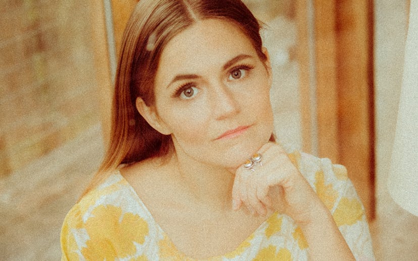 Erin Rae wearing a yellow floral pattern dress