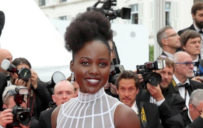 Lupita Nyong'o in a white dress on the Cannes Film Festival red carpet