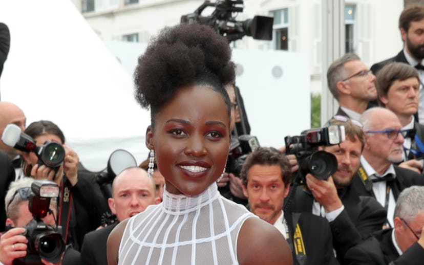 Lupita Nyong'o in a white dress on the Cannes Film Festival red carpet