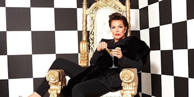 Kris Jenner, mother of famous Kardashian and Jenner sisters, sitting on a throne in a black and whit...
