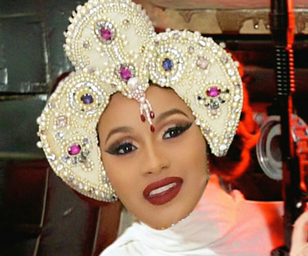 Cardi B with strong make-up and a bedazzled crown, photoshopped on princess Leia's body from Star Wa...