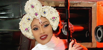 Cardi B with strong make-up and a bedazzled crown, photoshopped on princess Leia's body from Star Wa...