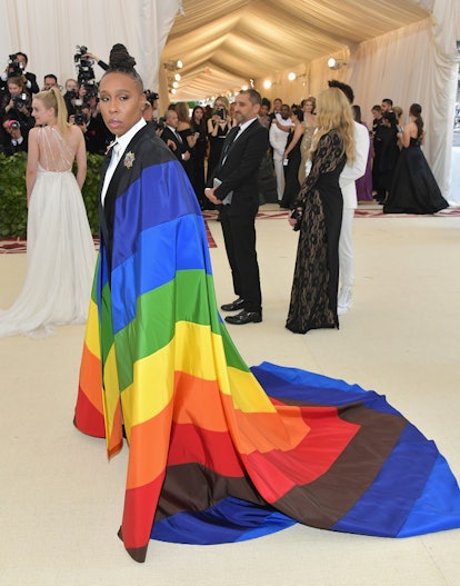 Lena Waithe wearing a white shirt with a rainbow cape at the 2018 Met Gala