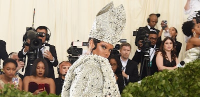 Rihanna at the Met gala in a bejeweled pope hat and robe