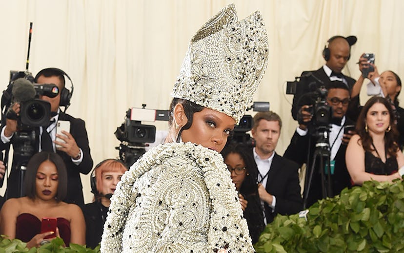 Rihanna at the Met gala in a bejeweled pope hat and robe