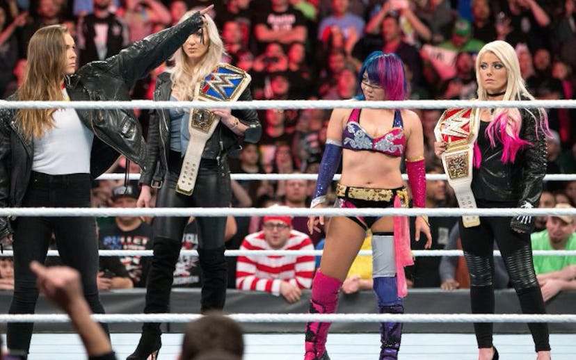 Ronda Rousey, Asuka, Charlotte Flair, and Alexa Bliss standing on stage for WWE Women’s Royal Rumble